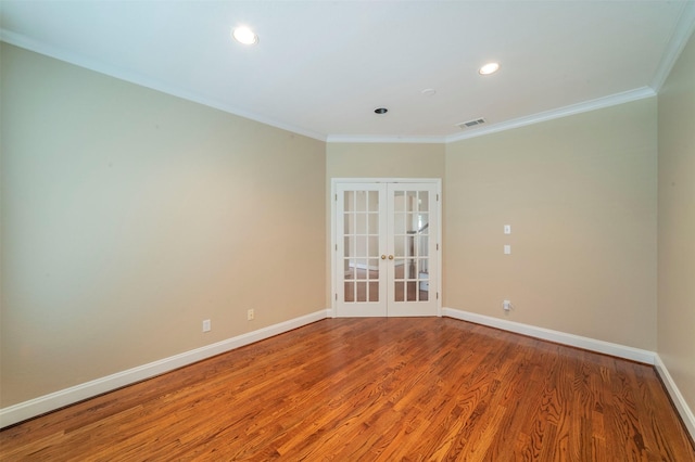 unfurnished room featuring french doors, crown molding, and wood-type flooring