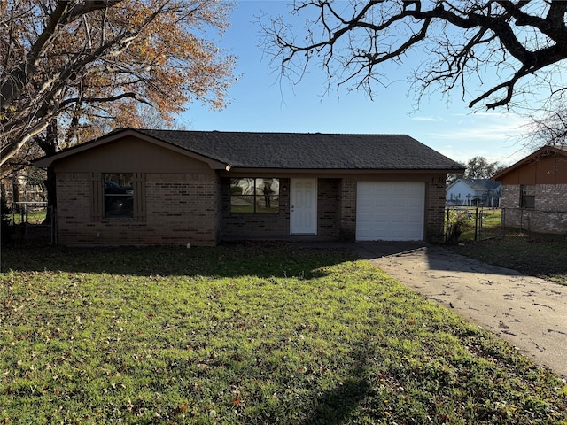 ranch-style home featuring a garage and a front lawn