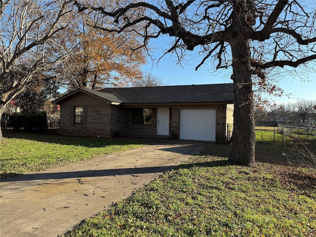 ranch-style house featuring a front lawn and a garage