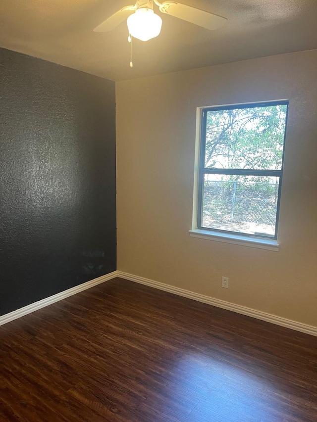 spare room featuring ceiling fan and dark hardwood / wood-style flooring