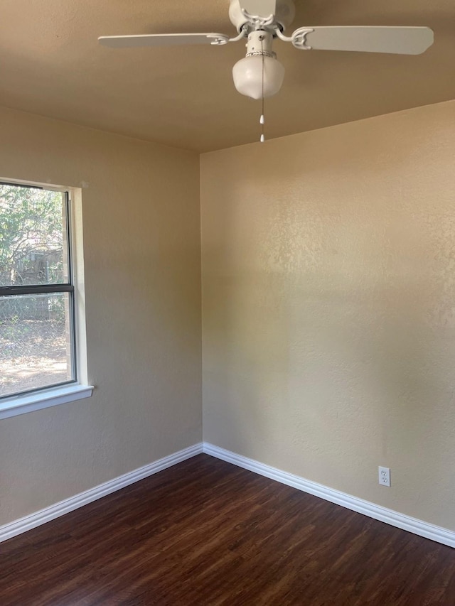 spare room with ceiling fan and dark hardwood / wood-style floors