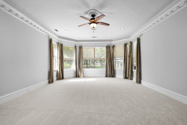 carpeted empty room with ceiling fan and ornamental molding