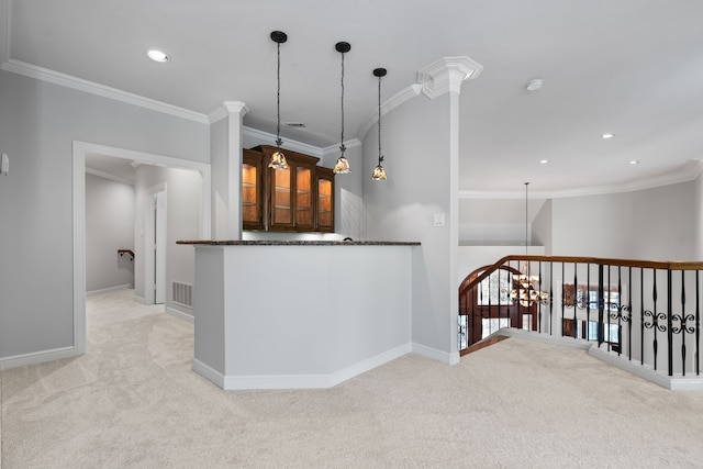 kitchen with pendant lighting, crown molding, dark stone countertops, an inviting chandelier, and light colored carpet