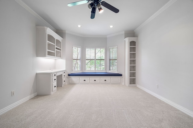 carpeted spare room with ceiling fan and crown molding