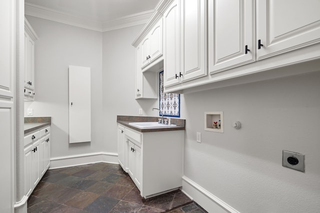 laundry room with cabinets, dark tile floors, washer hookup, sink, and ornamental molding