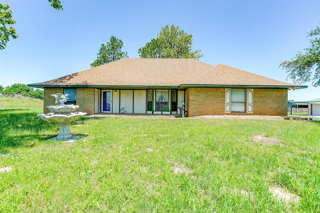 ranch-style home featuring a front yard