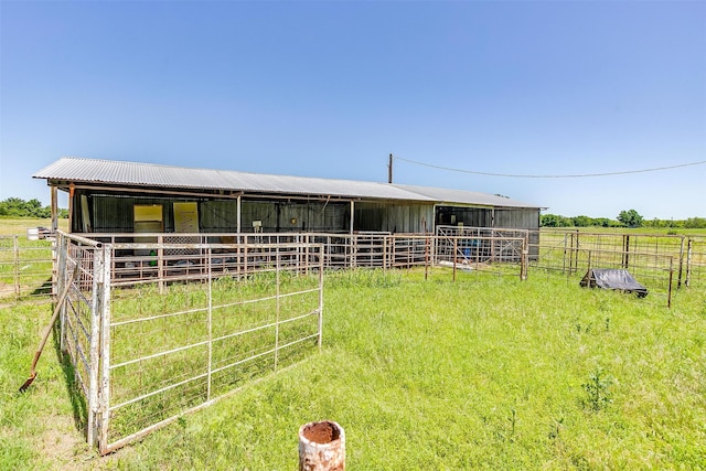 view of stable with a rural view and an outdoor structure