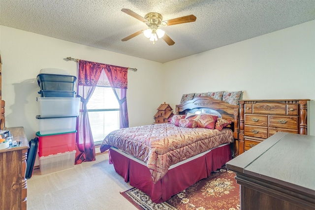 bedroom featuring carpet flooring, ceiling fan, and a textured ceiling