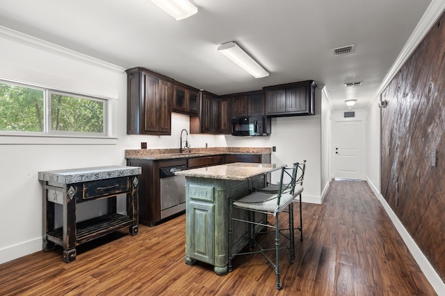 kitchen with light stone countertops, ornamental molding, a kitchen island, dark hardwood / wood-style flooring, and dishwasher