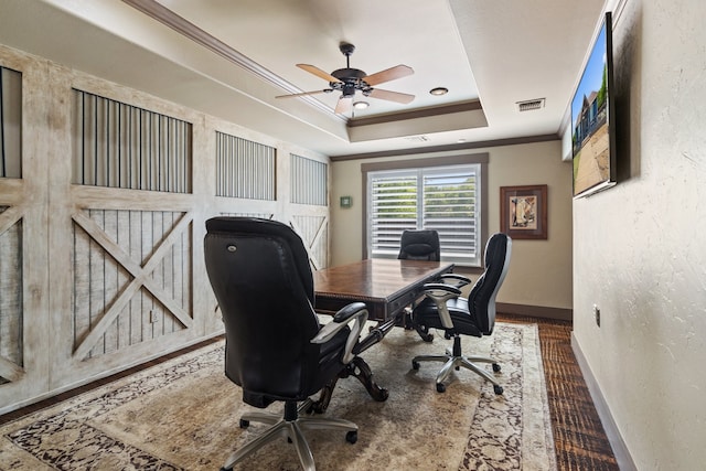 office with ceiling fan, a tray ceiling, and ornamental molding