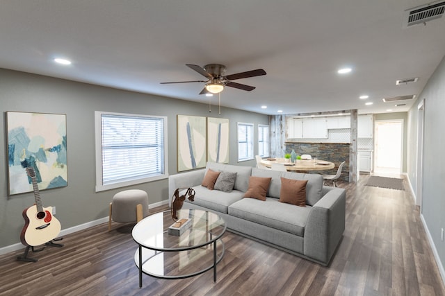 living room with ceiling fan, a healthy amount of sunlight, and dark hardwood / wood-style flooring