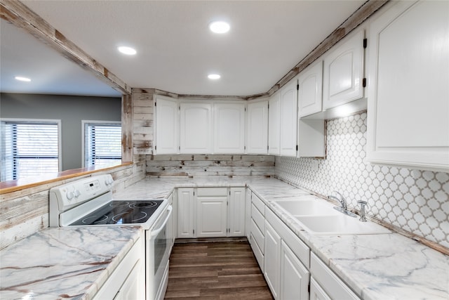 kitchen with dark wood-type flooring, sink, electric stove, white cabinetry, and backsplash