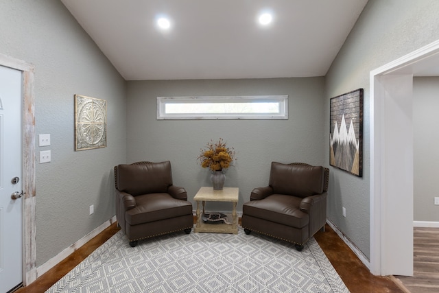 living area featuring light wood-type flooring and lofted ceiling