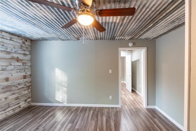 empty room featuring ceiling fan and hardwood / wood-style flooring