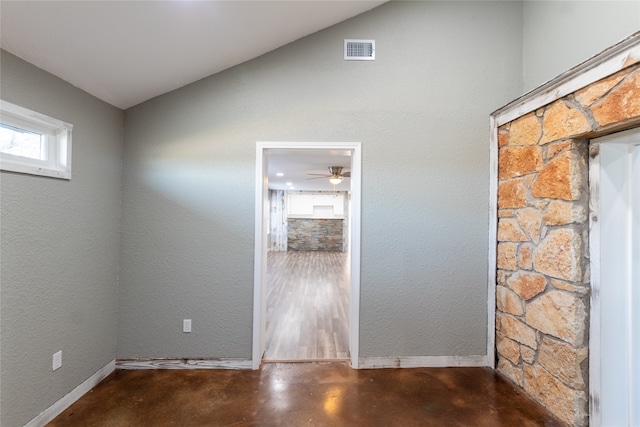 spare room featuring lofted ceiling and ceiling fan