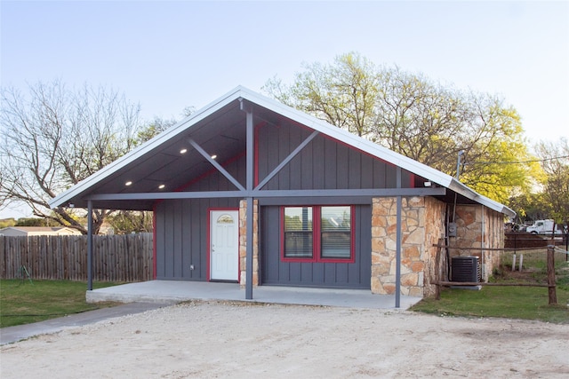 exterior space with a front yard and central AC