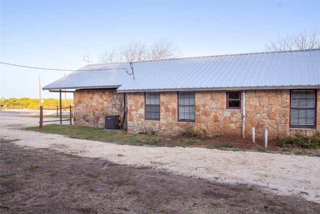 rear view of house featuring central AC