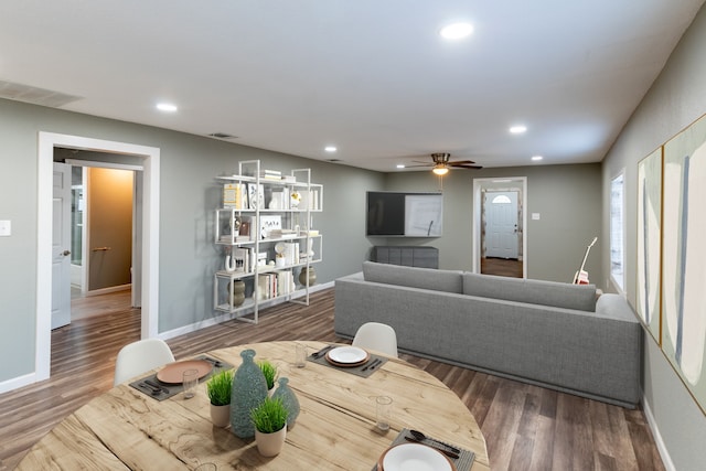 living room with wood-type flooring and ceiling fan