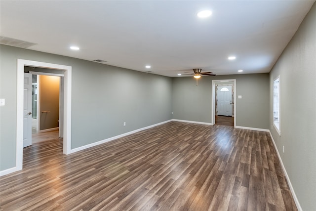 spare room with ceiling fan and dark wood-type flooring