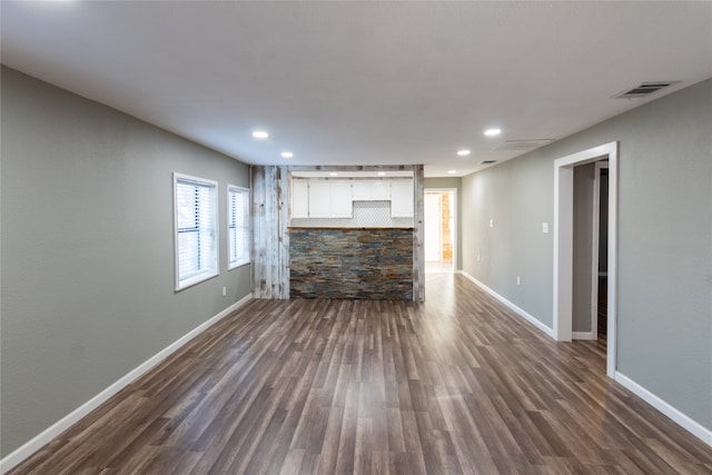 unfurnished living room featuring dark hardwood / wood-style flooring