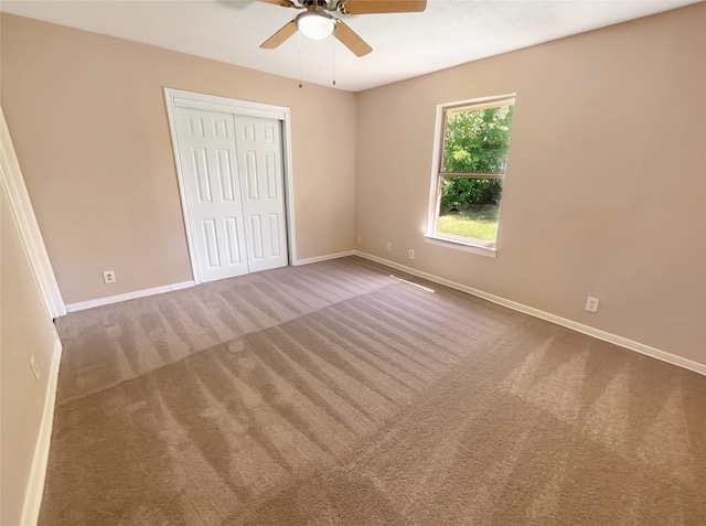 interior space featuring carpet flooring and ceiling fan