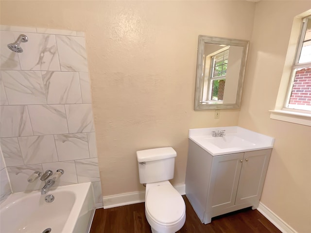 bathroom featuring plenty of natural light, wood-type flooring, and toilet