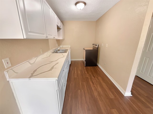 interior space featuring a textured ceiling, sink, dark wood-type flooring, and white cabinetry