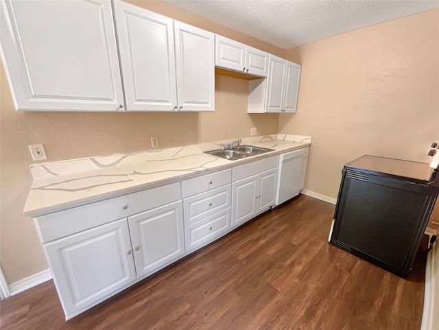 kitchen with a textured ceiling, sink, white cabinetry, dark hardwood / wood-style flooring, and white dishwasher