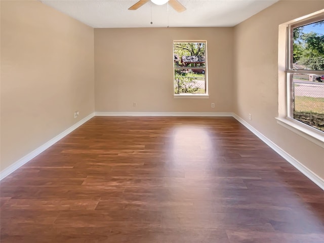 spare room with ceiling fan and dark hardwood / wood-style flooring