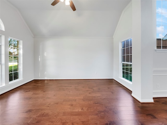 empty room with ornamental molding, lofted ceiling, ceiling fan, and dark hardwood / wood-style flooring