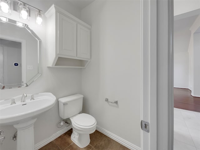 bathroom featuring tile patterned floors, toilet, and sink