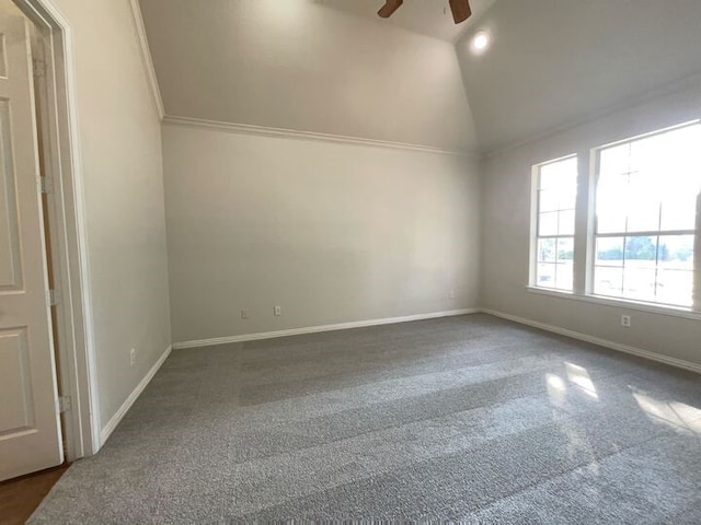 carpeted spare room with ornamental molding, vaulted ceiling, and ceiling fan