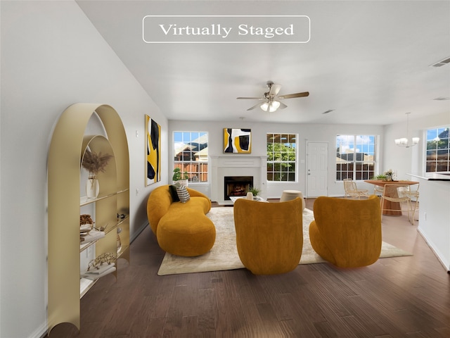 living room featuring ceiling fan with notable chandelier, hardwood / wood-style flooring, and a wealth of natural light