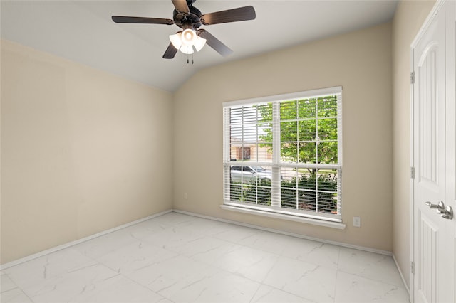 spare room featuring light tile flooring, ceiling fan, and vaulted ceiling