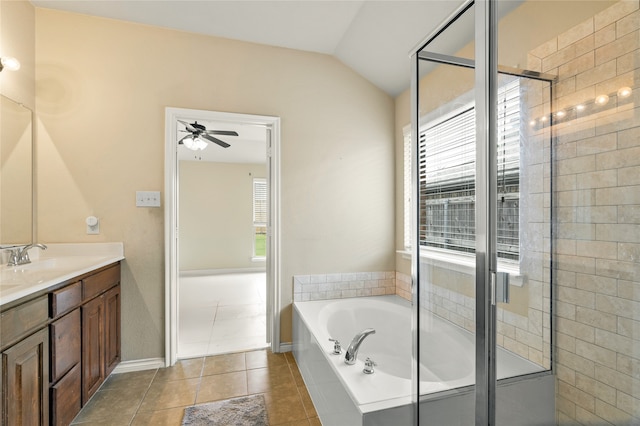 bathroom with lofted ceiling, ceiling fan, tile floors, separate shower and tub, and vanity