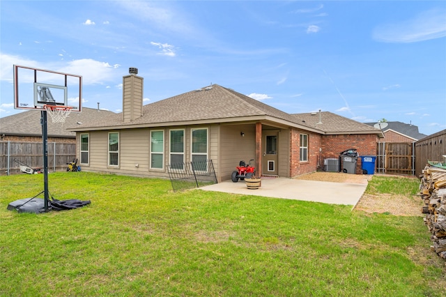 rear view of property with a lawn and a patio area