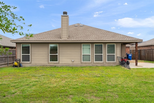 back of property with a patio area and a yard