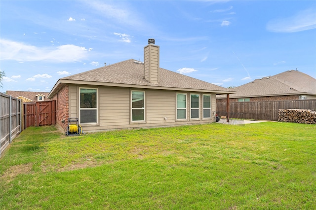 rear view of property with a yard