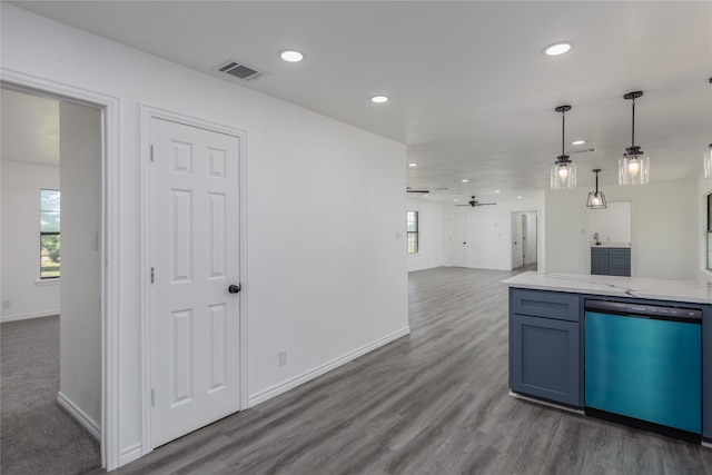 kitchen featuring dark colored carpet, light stone countertops, ceiling fan, dishwasher, and pendant lighting