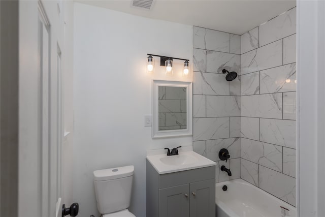 full bathroom with tiled shower / bath combo, vanity, and toilet