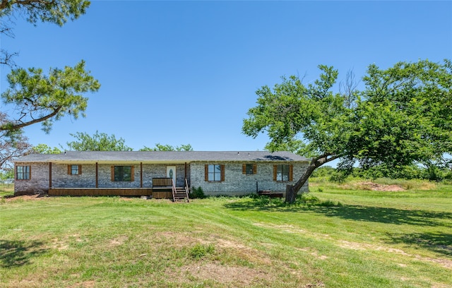 view of front of house with a wooden deck and a front lawn