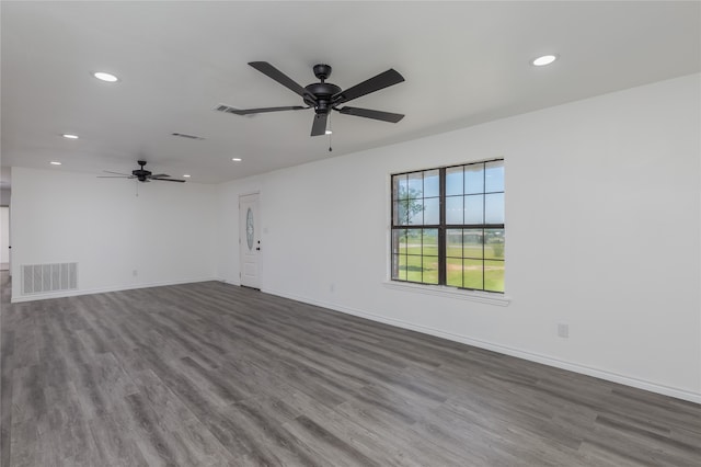 empty room featuring dark hardwood / wood-style flooring and ceiling fan