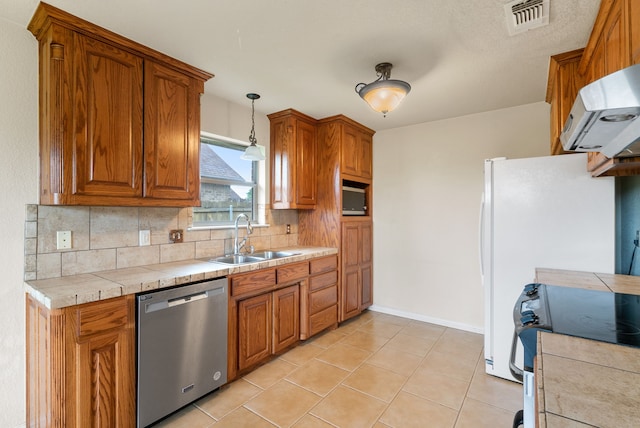 kitchen featuring decorative light fixtures, backsplash, dishwasher, range, and sink