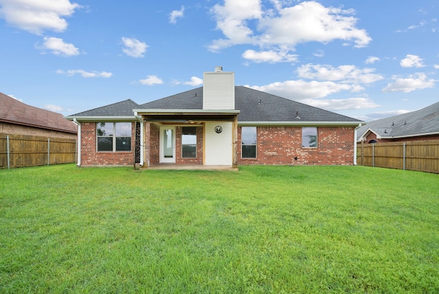 rear view of house featuring a patio and a lawn