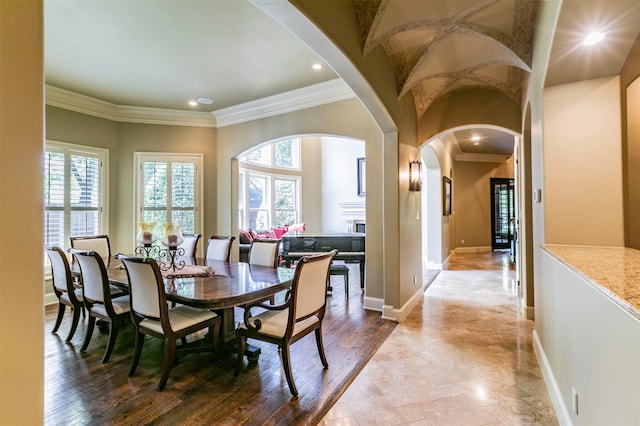 tiled dining area featuring crown molding