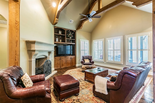 living room featuring wood-type flooring, beam ceiling, ceiling fan, and high vaulted ceiling