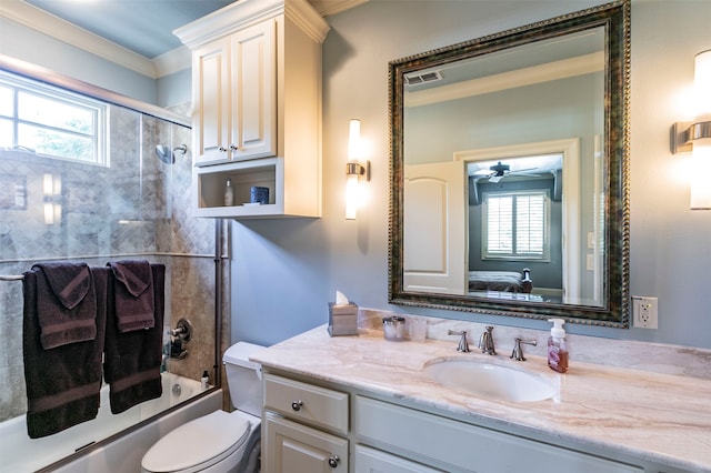 full bathroom with crown molding, vanity, bath / shower combo with glass door, toilet, and ceiling fan