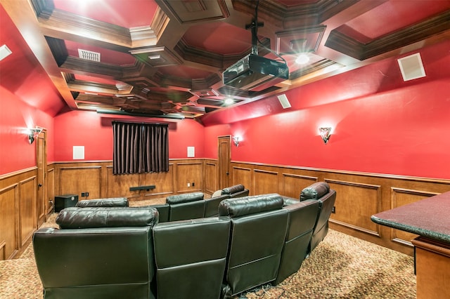 carpeted home theater room with coffered ceiling and ornamental molding