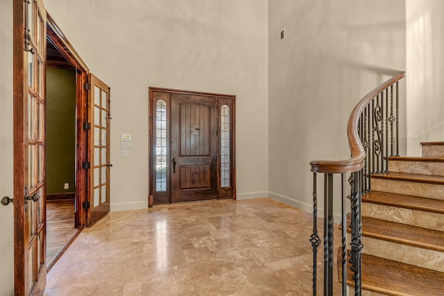 foyer with a high ceiling and french doors