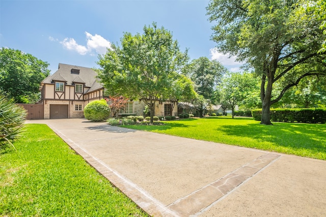 view of front of property with a front lawn and a garage